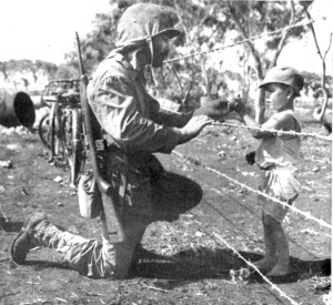 Photograph of Marine giving candy to an interned child