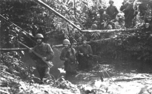 Photograph of Army troops moving along the Munda Trail