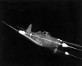 Photograph of P-39 Airacobra firing its guns at
                night