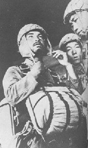 Photograph of Tsukada Rikichi adjusting his helmet