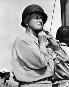 Photograph of Admiral Chester Nimitz
        donning a helmet