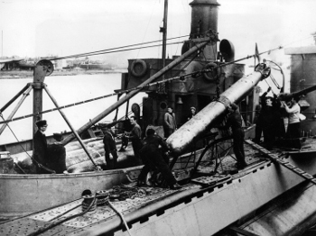 Photograph of Mark
          VIIItorpedo being loaded onto submarine in Polish service