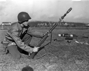 Photograph of soldier preparing to fire a rifle
        grenade