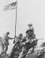 The first flag goes up atop Suribachi