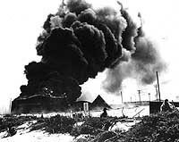 Burning facilities on Midway following Japanese air strike